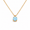 Gold necklace with a blue gemstone pendant on a white background