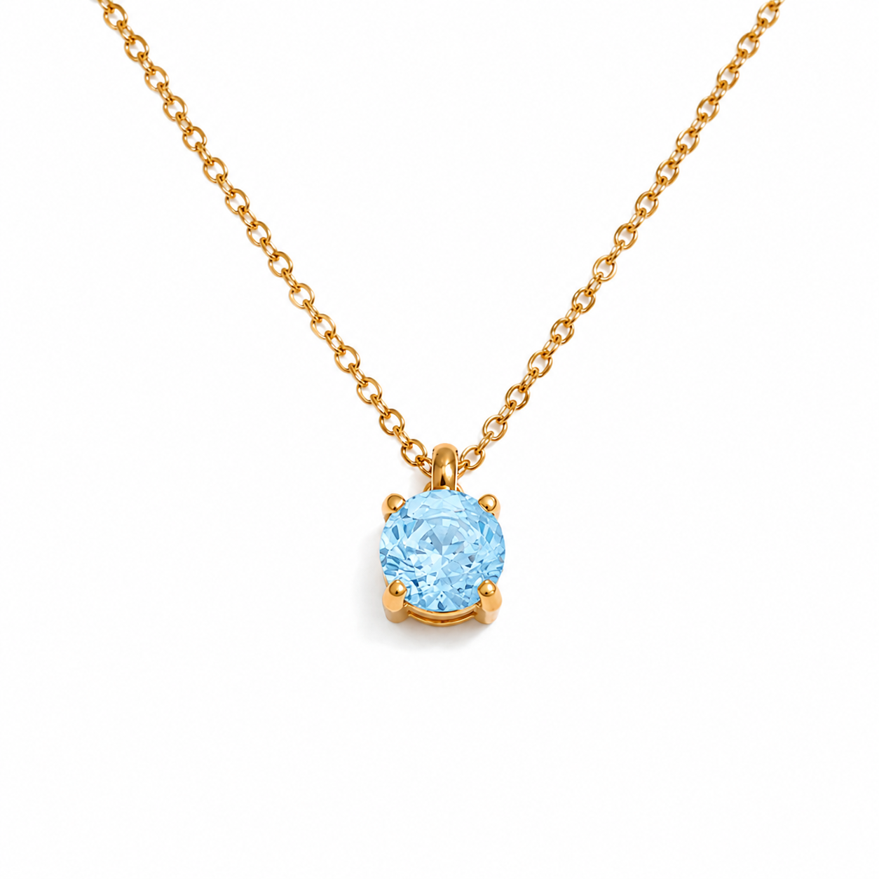Gold necklace with a blue gemstone pendant on a white background